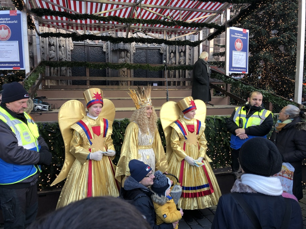 Gold-costumed figures greeting visitors at Nuremberg’s Christmas market.