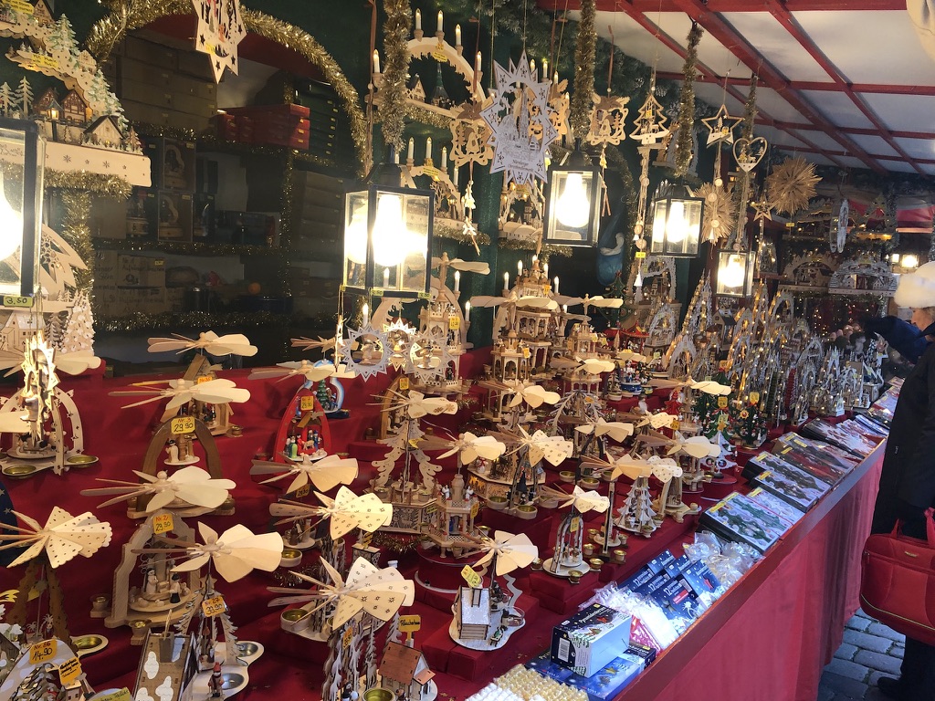 Wooden Christmas pyramids and hanging decorations at the market.