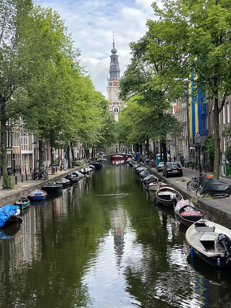 Boats and leafy streets along an Amsterdam canal.