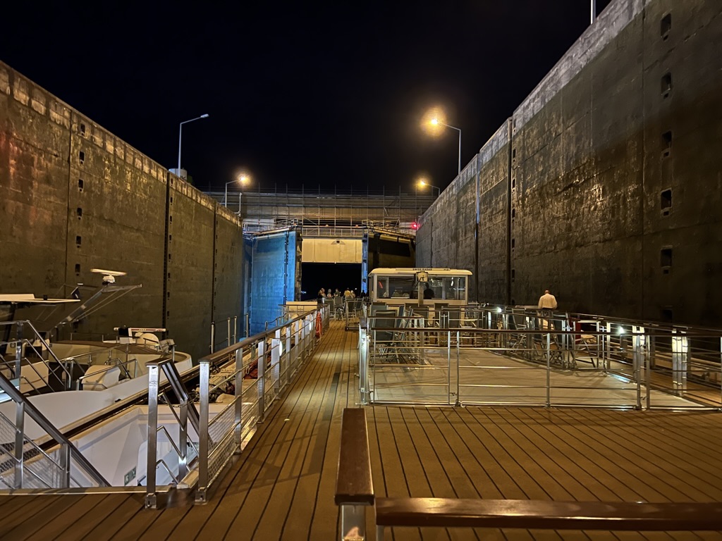 A nighttime view from the Longship inside a lock.
